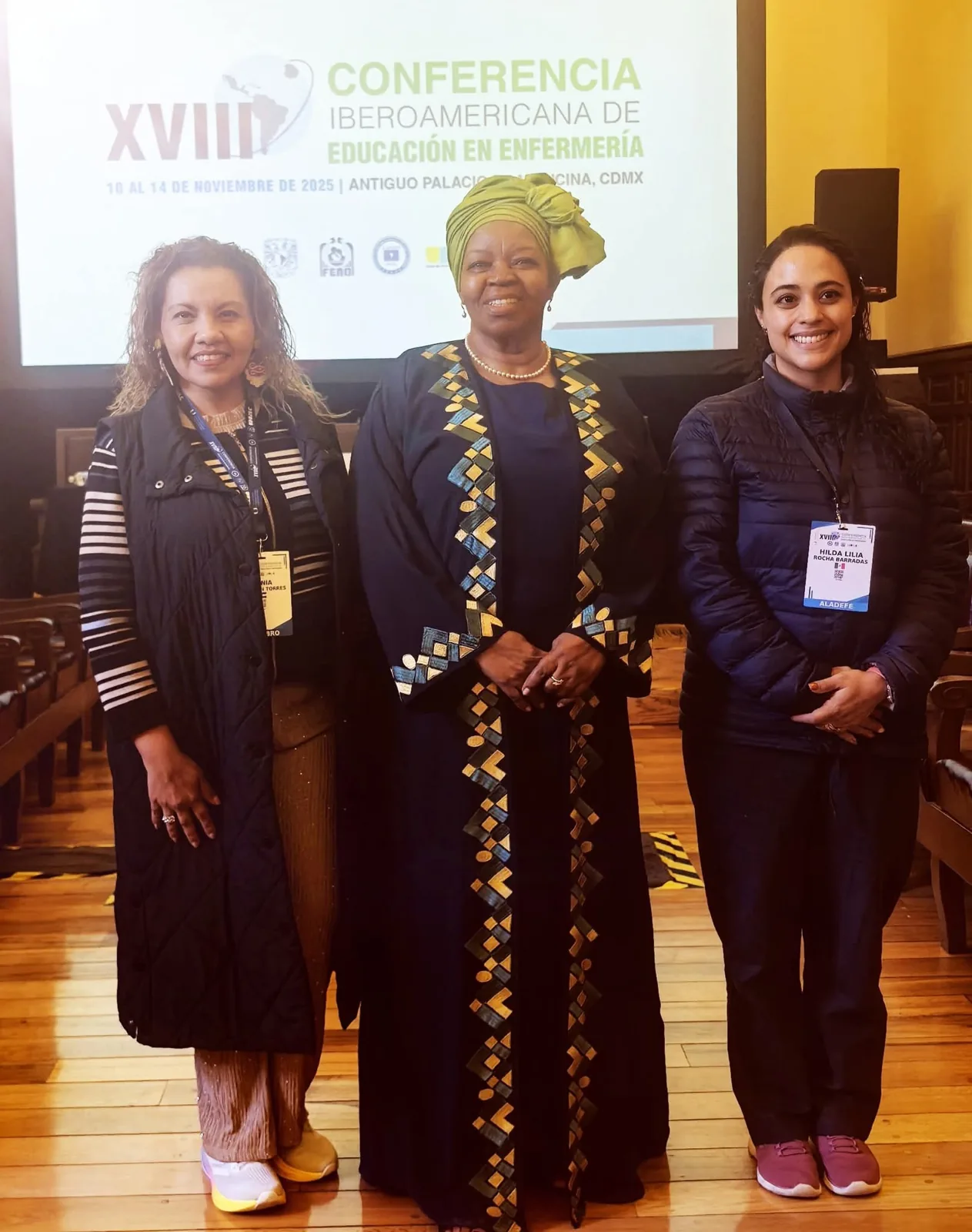 Professor Sheila Tlou standing with two conference delegates.