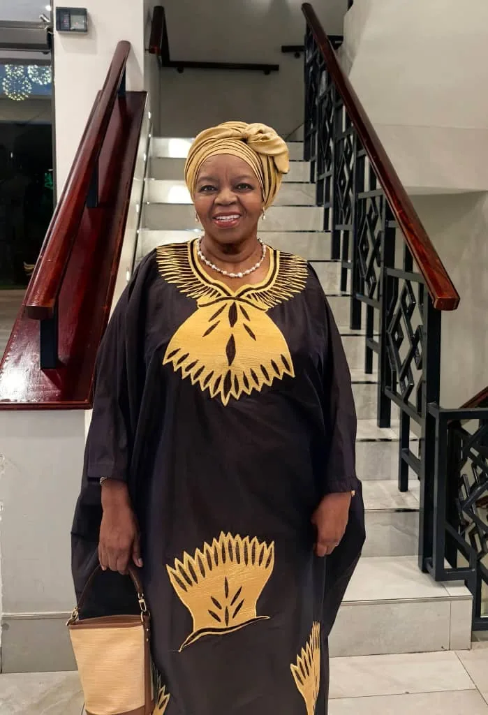 Professor Sheila Tlou standing in a formal interior.