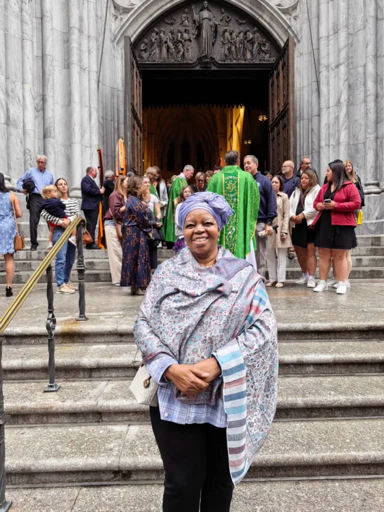 Professor Sheila Tlou standing on the steps of a public building.
